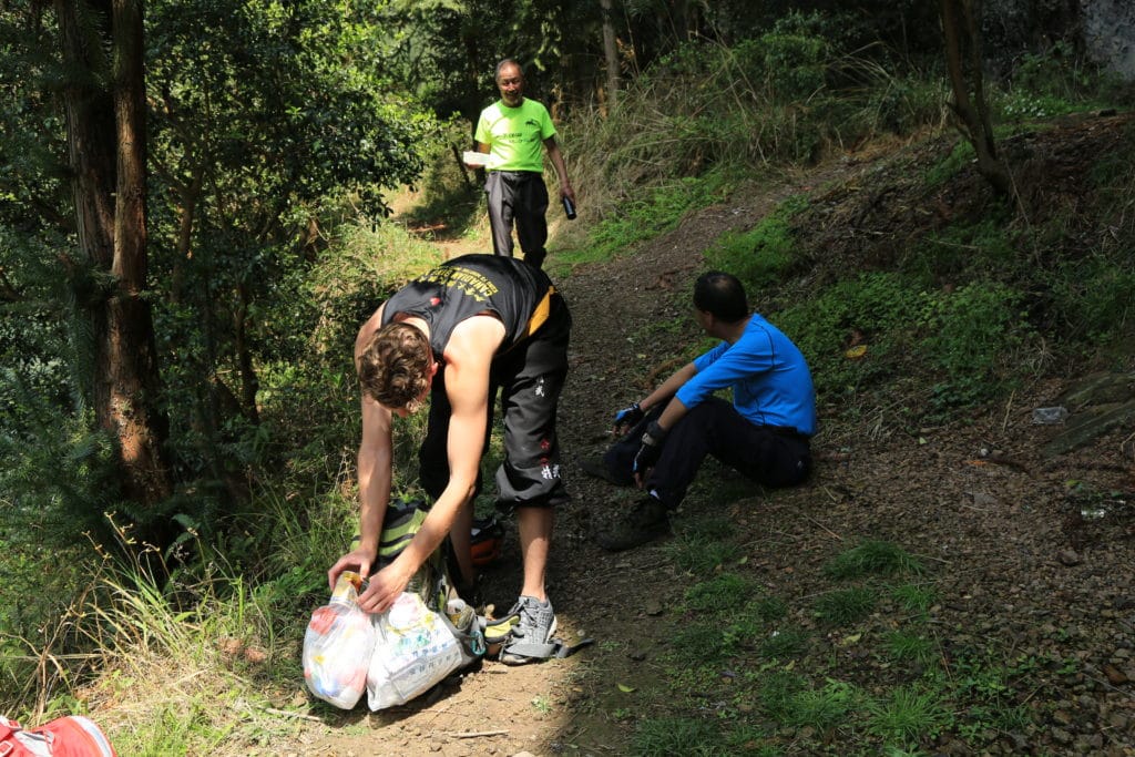 Trashtag Challenge, Hiking Version, Man Picking up Garbage while hiking